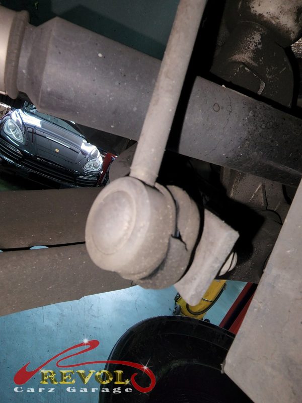 The old worn anti-roll bar drop links removed, ball joints loose.