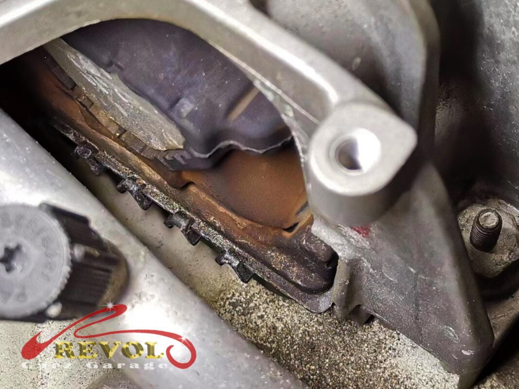 The worn engine mount with cracked and sunken rubber on the Volkswagen Golf.