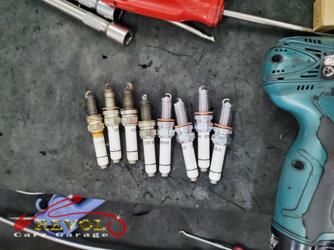 The old worn spark plugs removed from the engine.