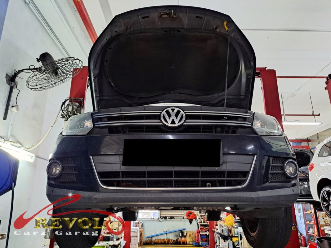 The under-dash trim removed to reach the blower assembly on the Volkswagen Tiguan.
