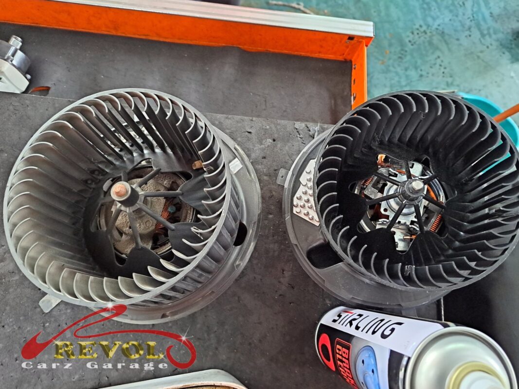 The old cabin blower motor removed beside the new VW-spec replacement.