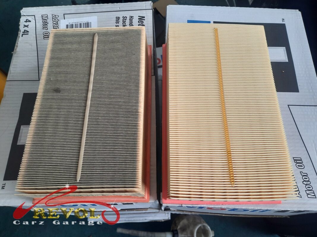 The old air filter beside the new VAG-spec replacement.