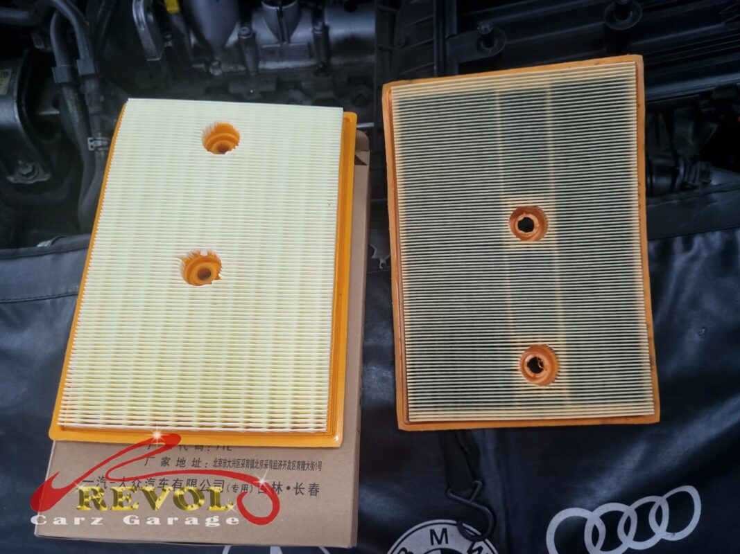 The old air filter beside the new VAG-spec replacement.