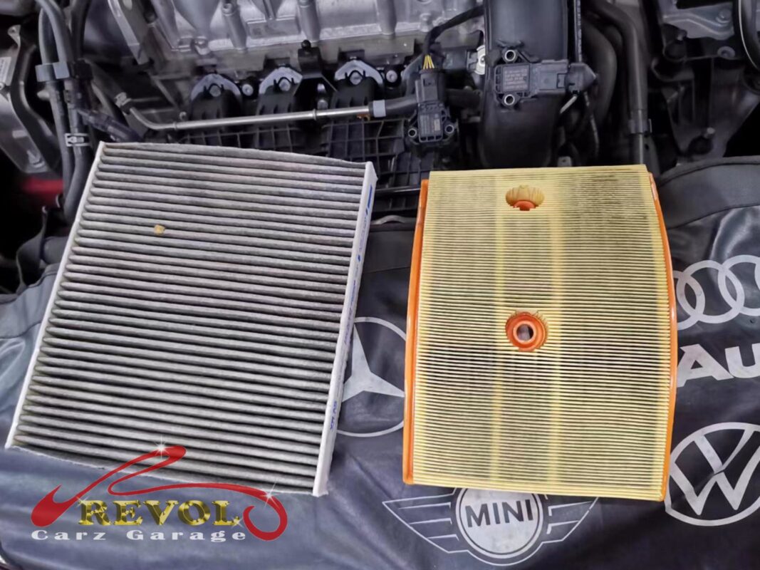 The old air filter beside the new VAG-spec replacement.