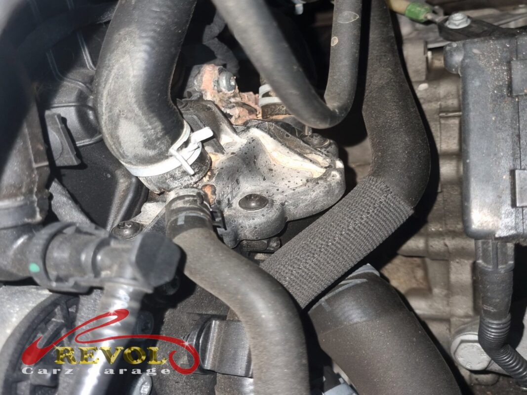 The old thermostat housing removed from the engine.
