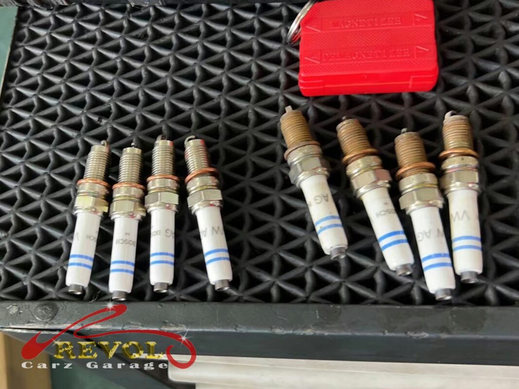The old worn spark plugs removed from the engine.