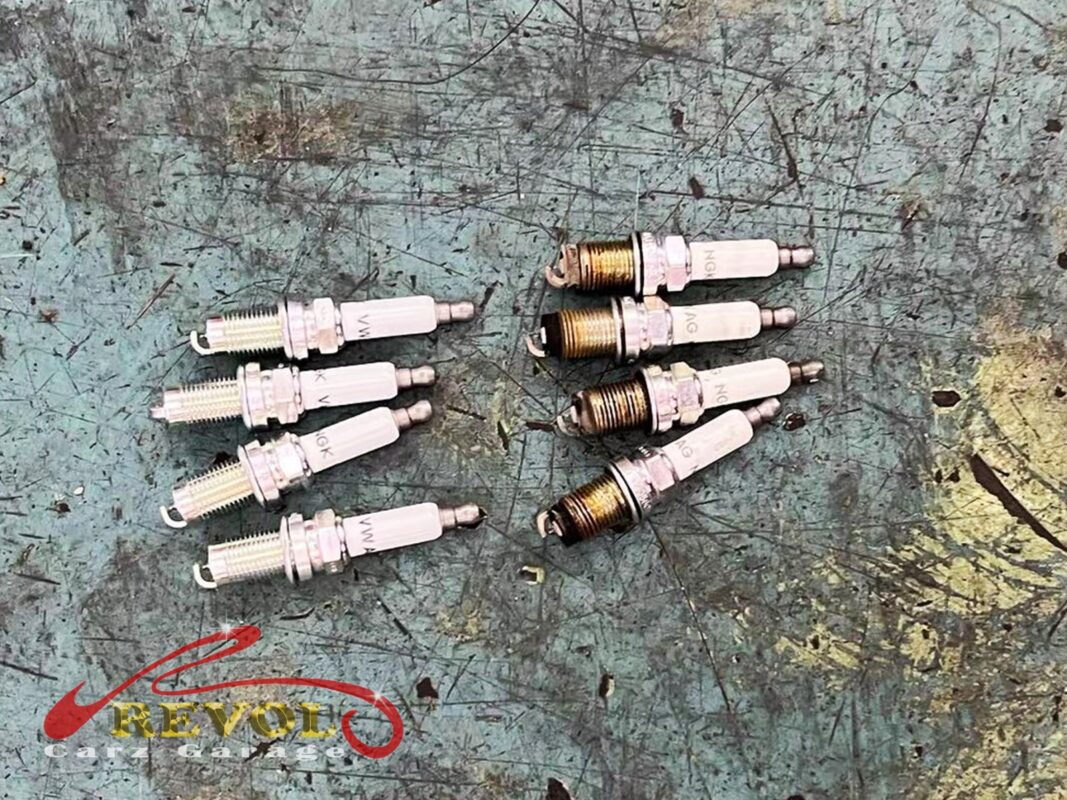 The old worn spark plugs removed from the engine.