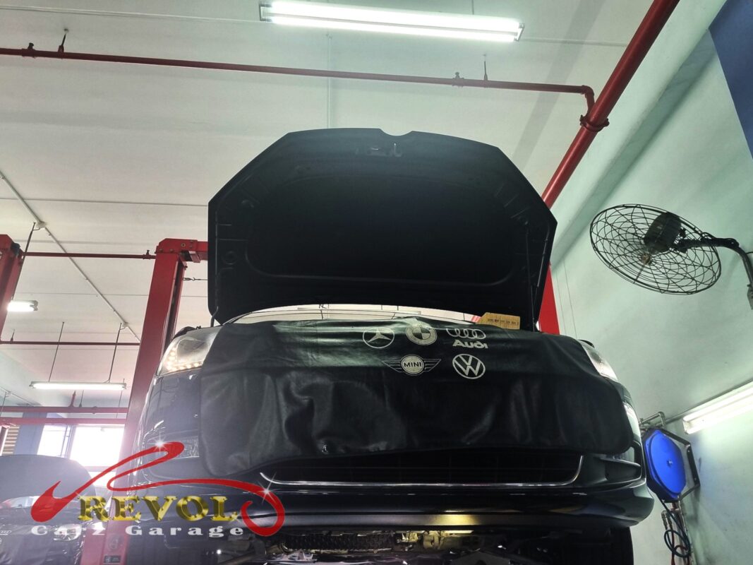 The Sharan up on the two-post lift, fender cover on, in for the oil leak.