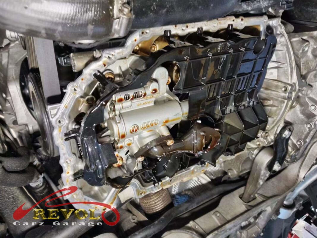 The lower sump pan off, the upper sump section and oil pump exposed above.