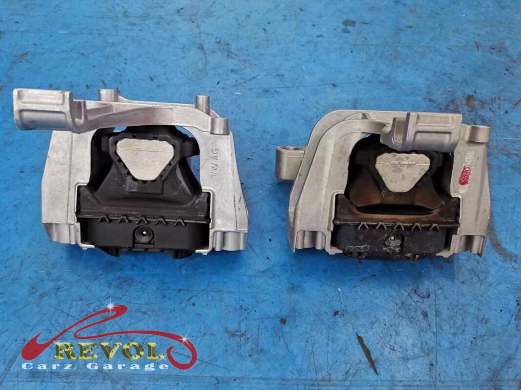 The old engine mount (right, oily and sagging) beside the new VAG-spec replacement (left).