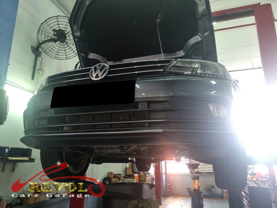 The Jetta up on the two-post lift, hood open, in for the heavy idle vibration.