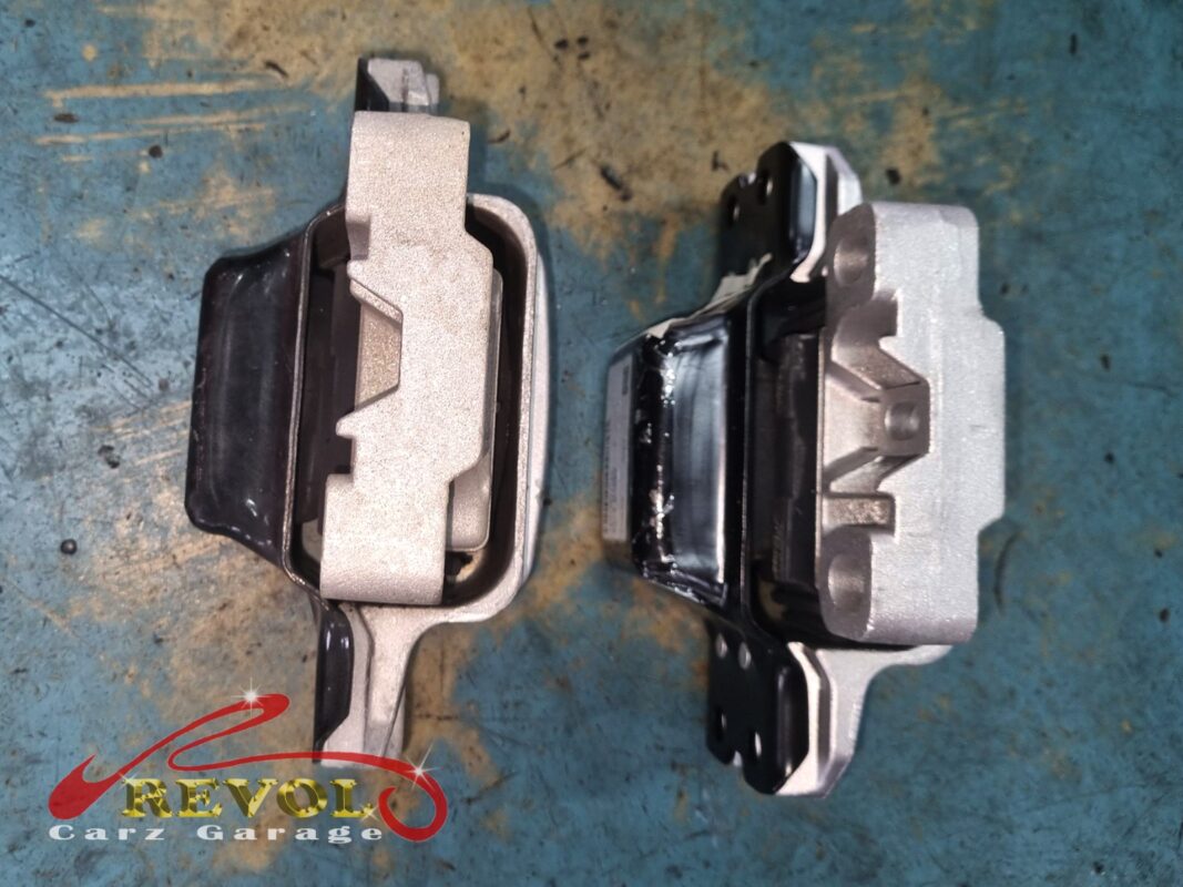 The old engine mount (right, oily) beside the new VAG-spec replacement (left).