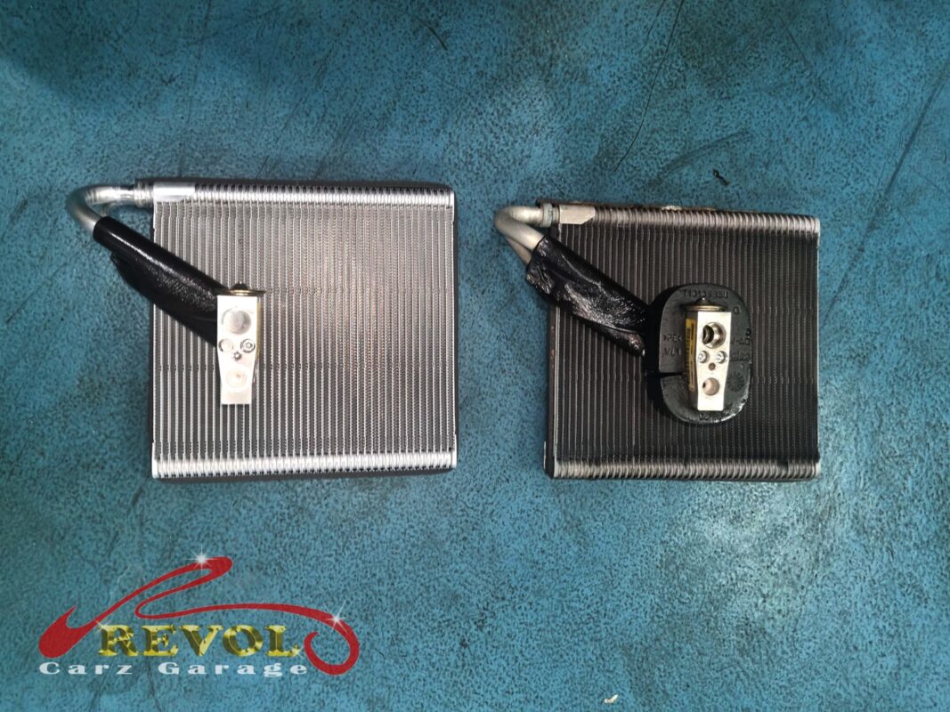 The old cooling coil (right, fins grimed over) beside the new VAG-spec replacement (left).