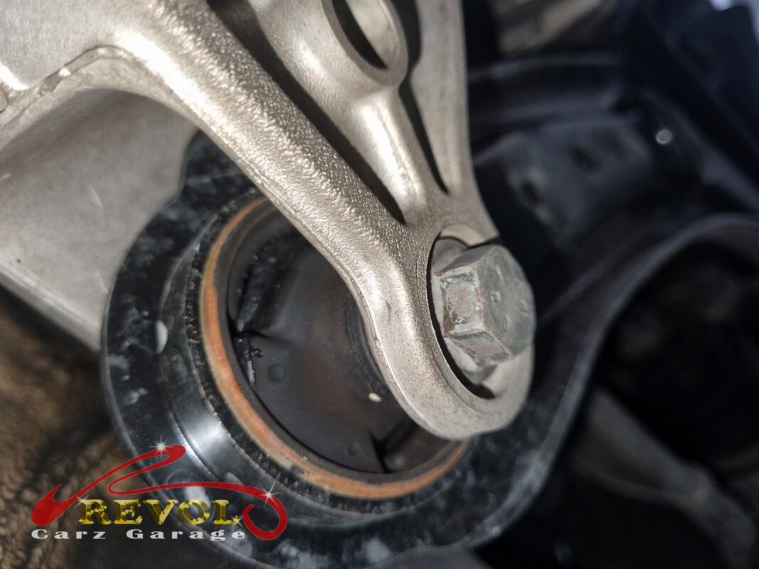 The lower-arm bush split through, the rubber cracked around the bolt.