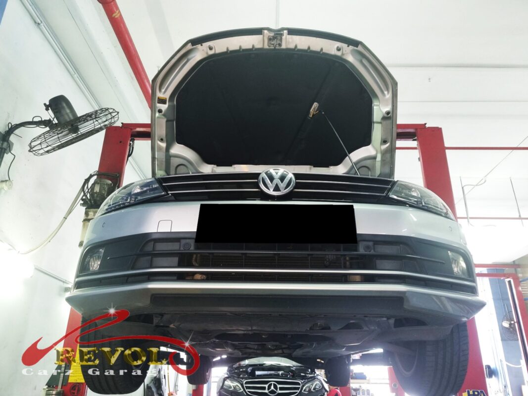 The Jetta up on the two-post lift, hood open, in for the clunk and the vague steering.
