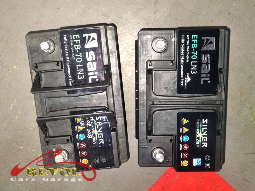 Failed battery lifted out, light corrosion at the terminals visible.