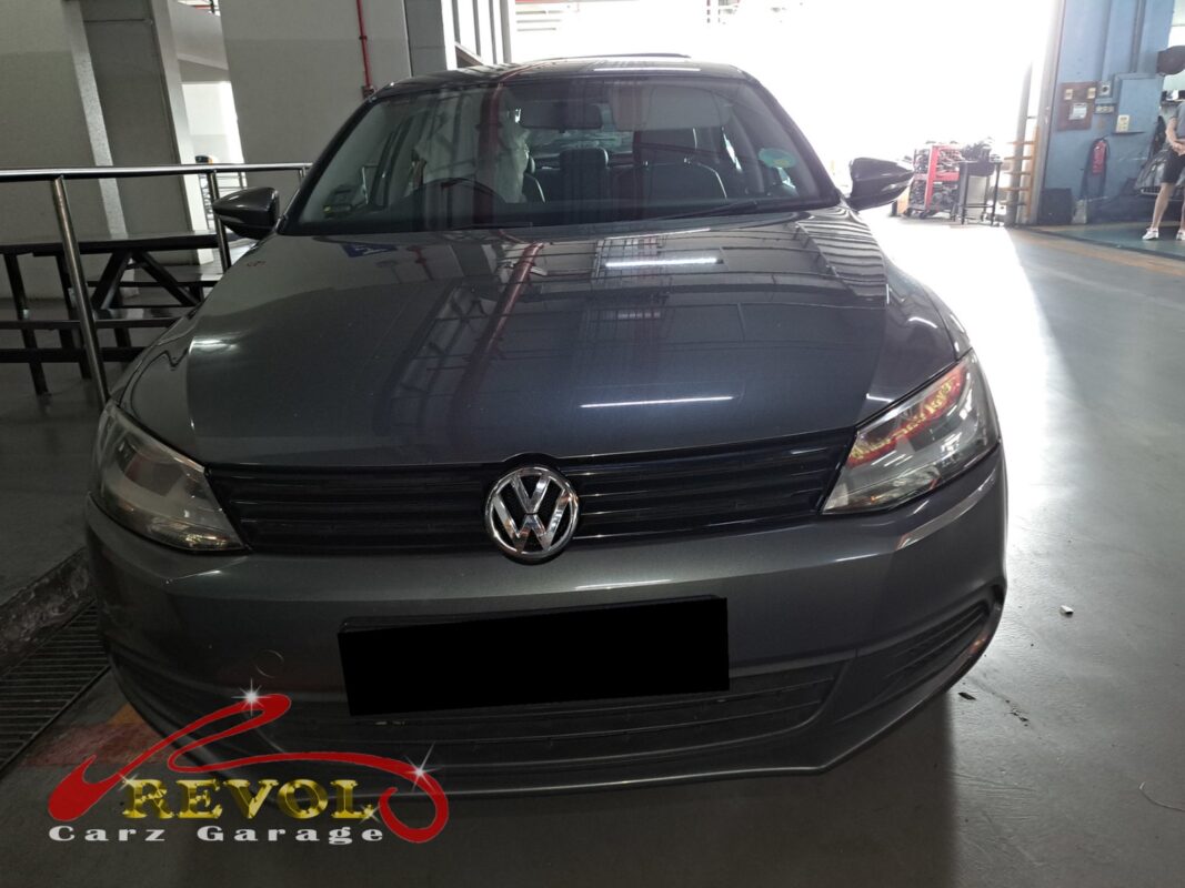 Volkswagen Jetta on the workshop lift with the front wheel off for bearing replacement.