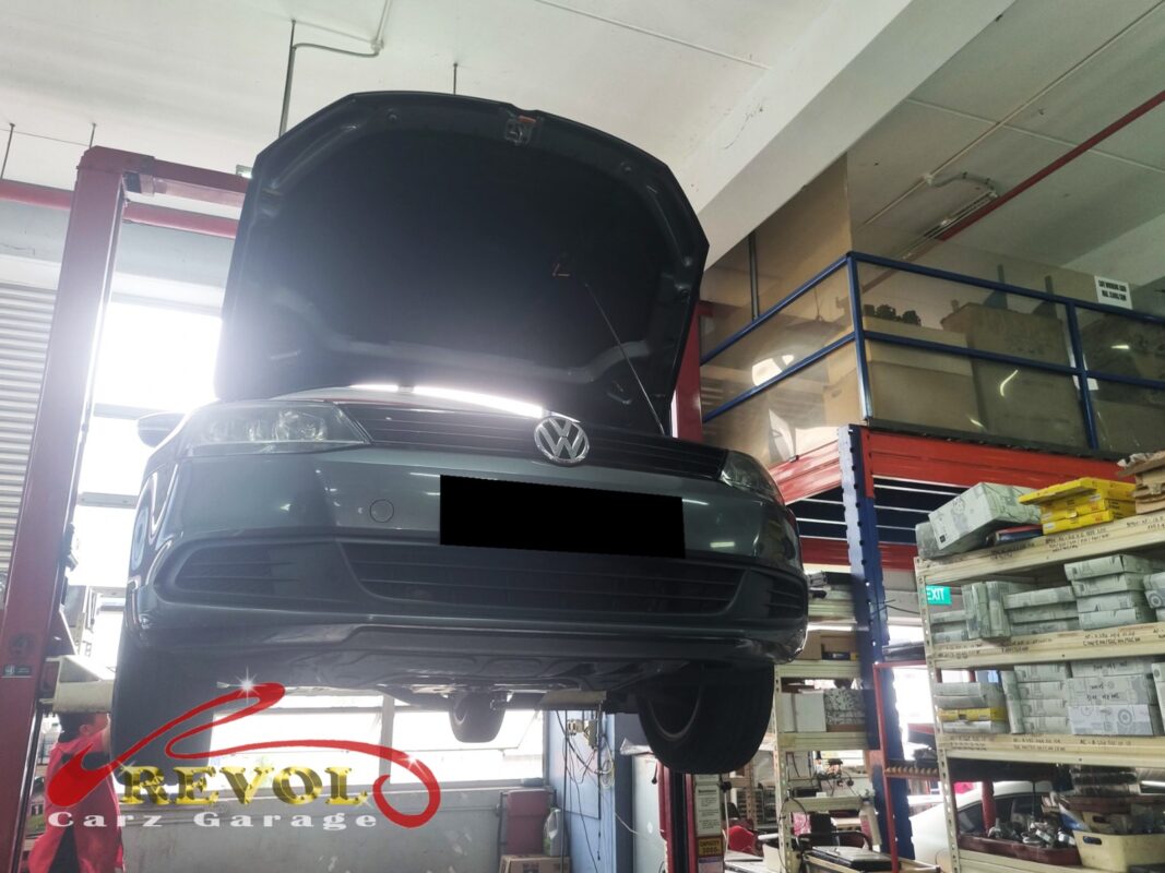 The Jetta up on the two-post lift, bonnet open, in for the wheel noise, the steering vibration and the new ABS light.