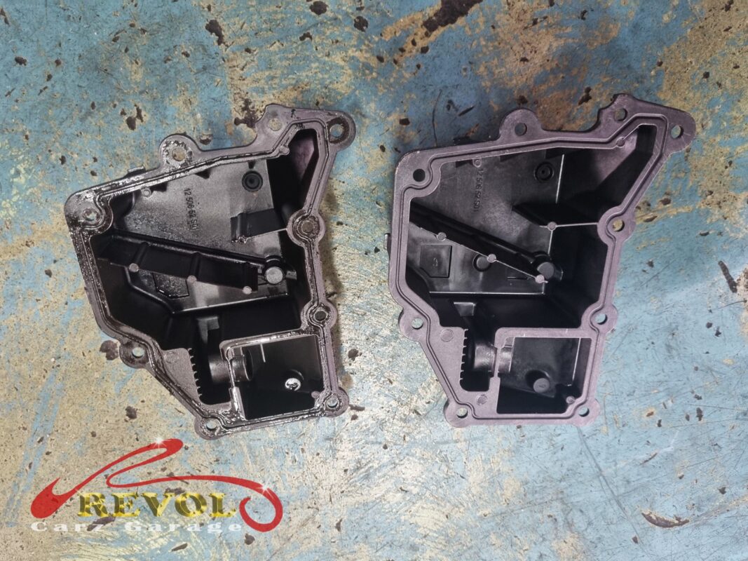 The old oil separator unit (left) beside the new VAG-spec replacement (right), the internal baffles visible.