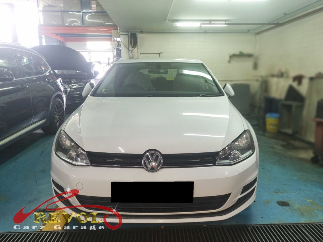 Volkswagen Golf in the workshop for spark plug replacement.