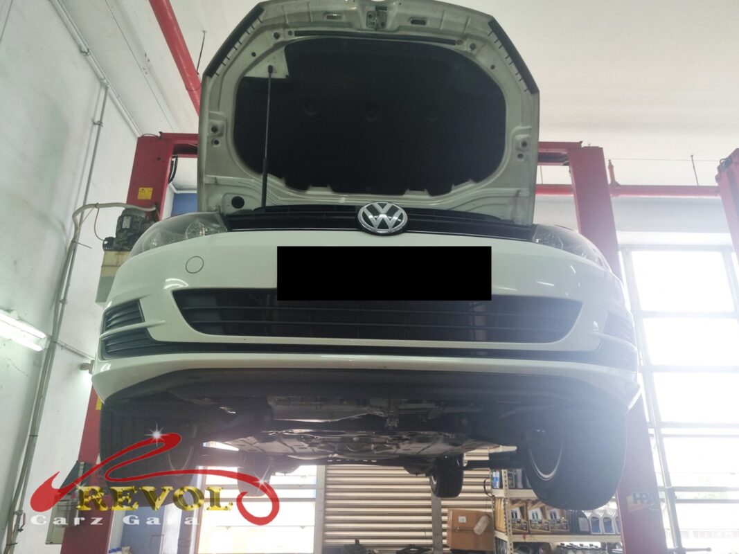 The Golf up on the two-post lift, bonnet open, in for the power loss, the vibration and the hesitation off the line.