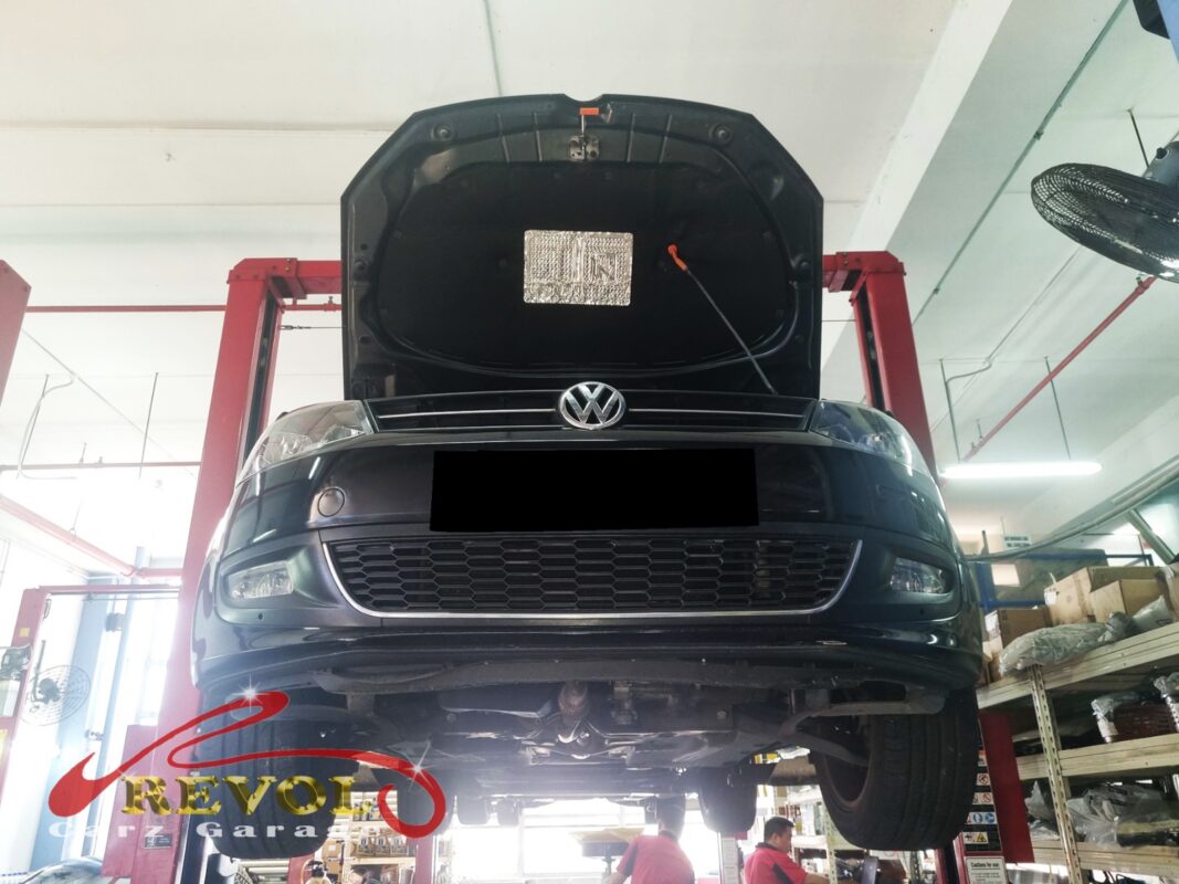 The Polo up on the two-post lift, bonnet open, in for the climbing gauge and the coolant traces.