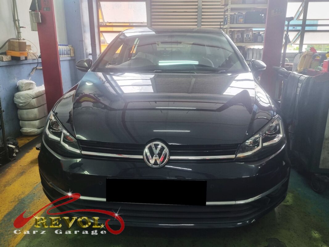Volkswagen Golf on the workshop lift with wheels off for brake pad and rotor replacement.