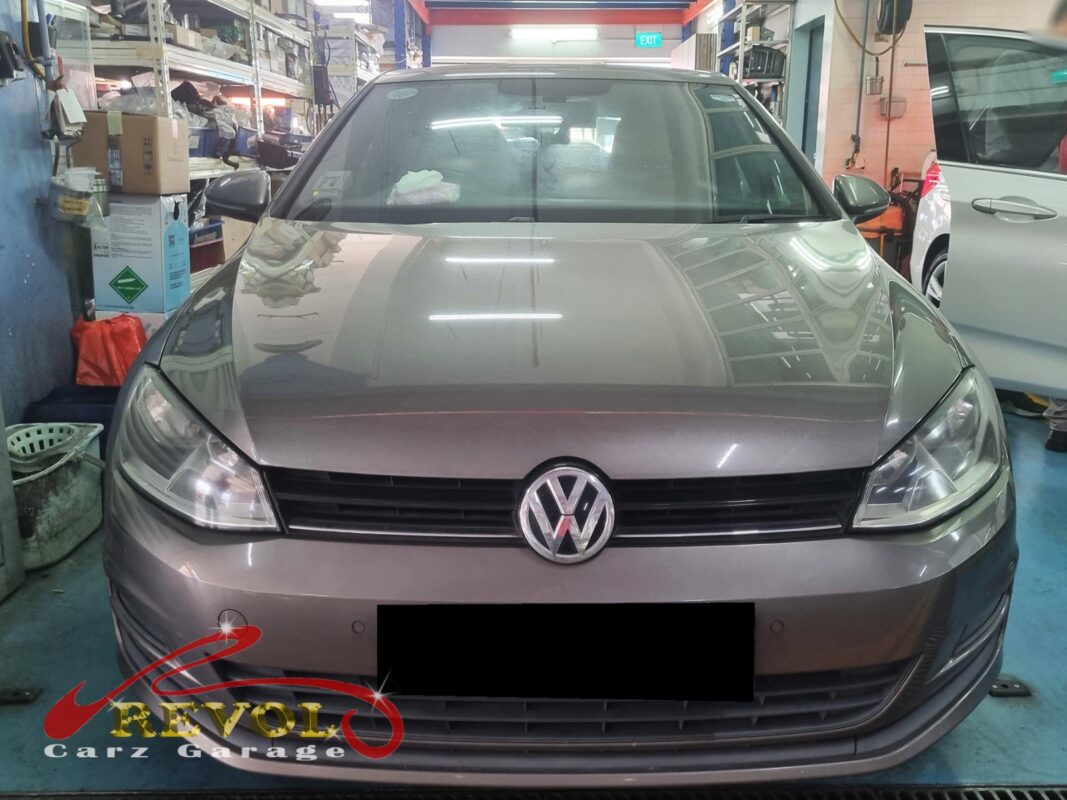 Volkswagen Golf with the front of the engine open for timing belt kit replacement.
