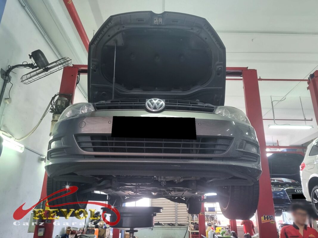 The Golf up on the two-post lift, bonnet open, in for the timing belt service.