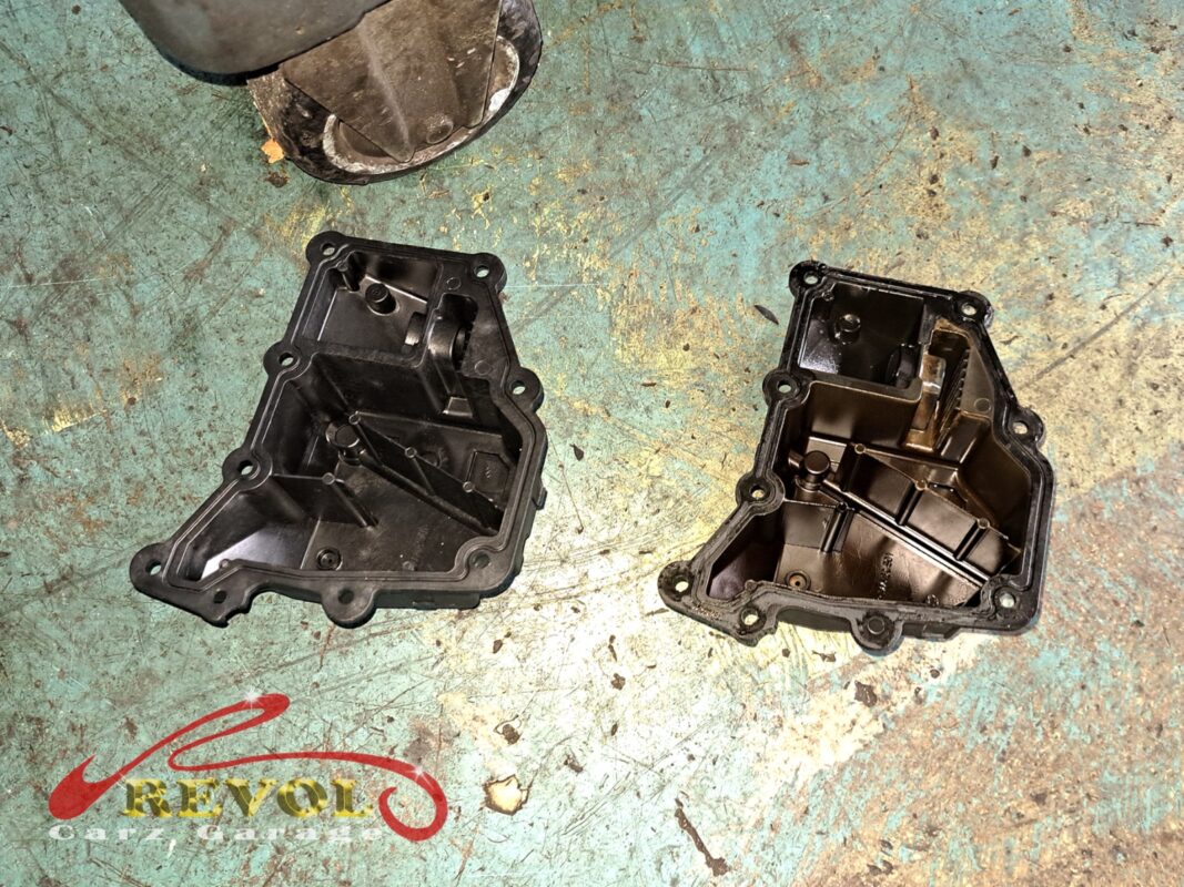 The old oil separator cover (right) beside the new VAG-spec replacement (left), with a fresh diaphragm and seal.