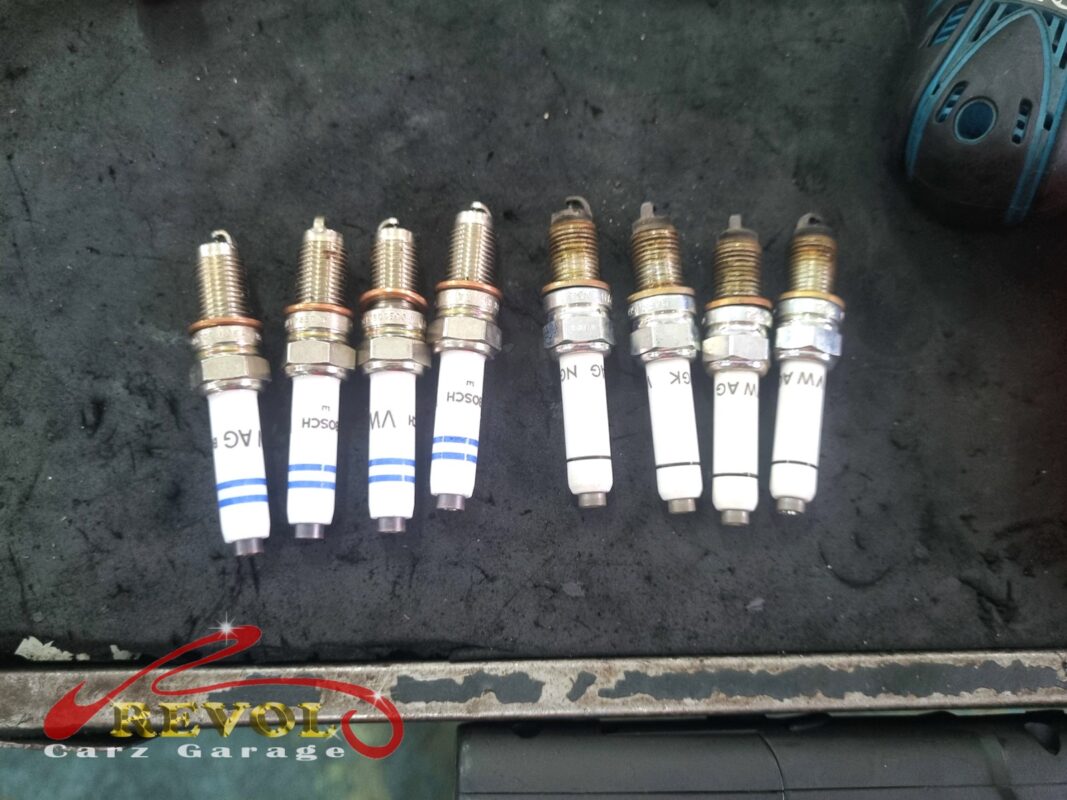 The four new VAG-spec spark plugs (left) beside the four worn originals (right).