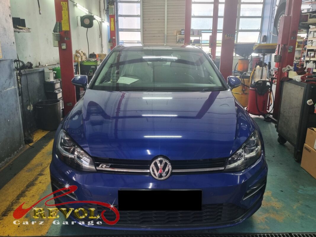 Volkswagen Golf on the workshop lift for coolant pump replacement.