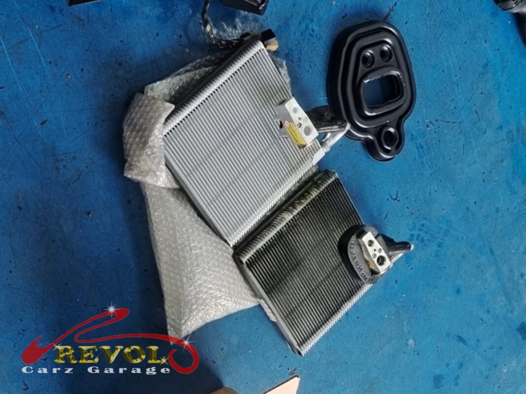 The new VAG-spec evaporator core (left, in wrap) beside the old one (right), with a fresh foam seal.