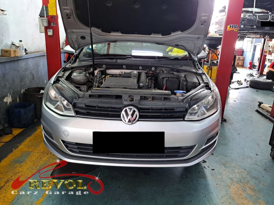 Volkswagen Golf with the front of the engine open for timing belt kit replacement.