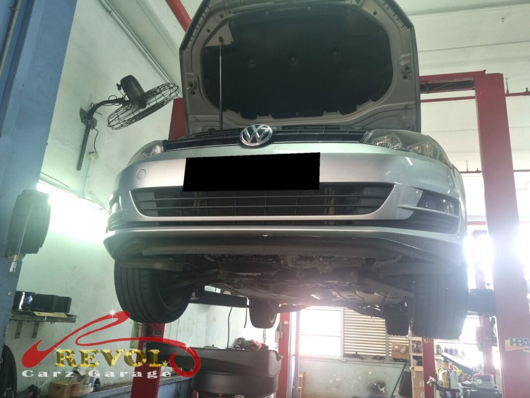 The Golf up on the two-post lift, bonnet open, in for the scheduled timing belt service.