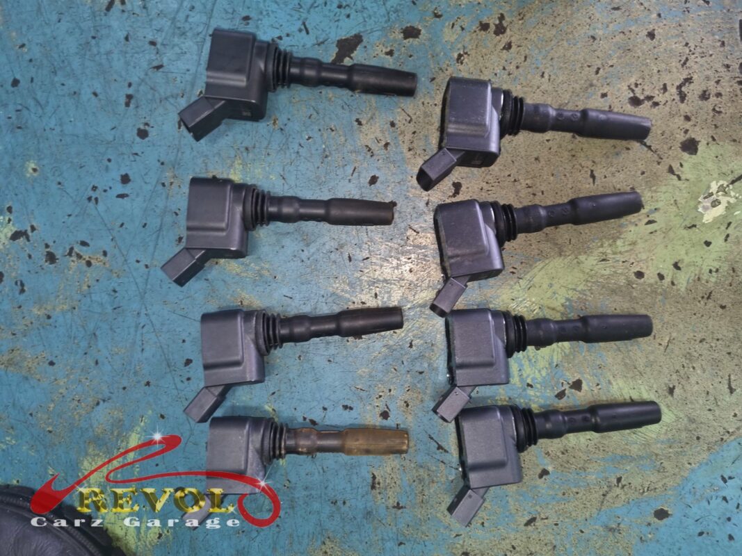 The ignition coils laid out, the four old units beside the four new VAG-spec replacements.