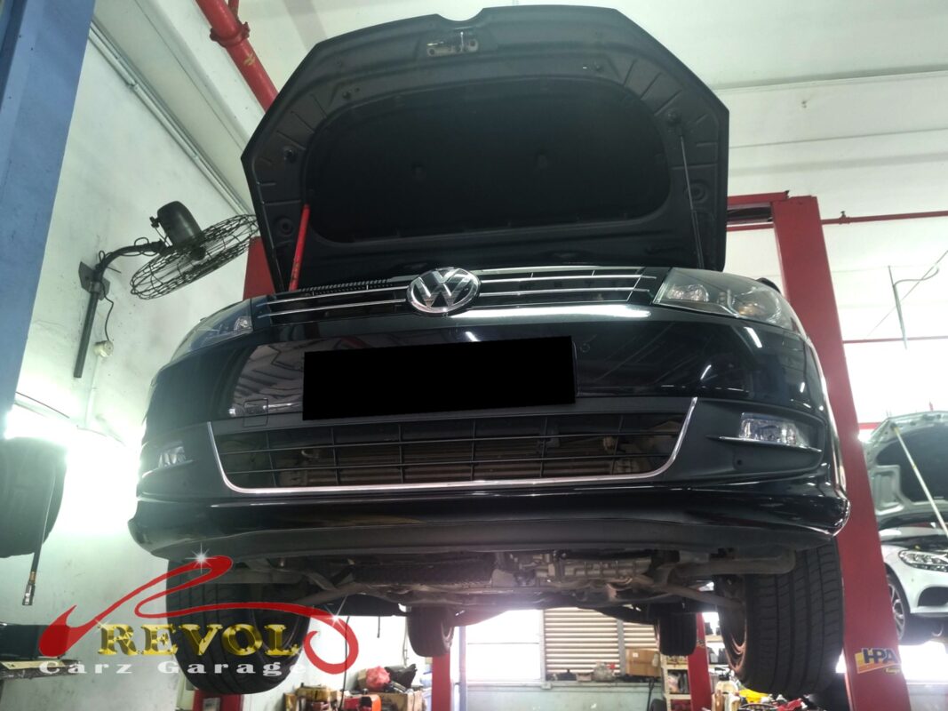 The Sharan up on the two-post lift, bonnet open, in for the clunk and the vague steering.