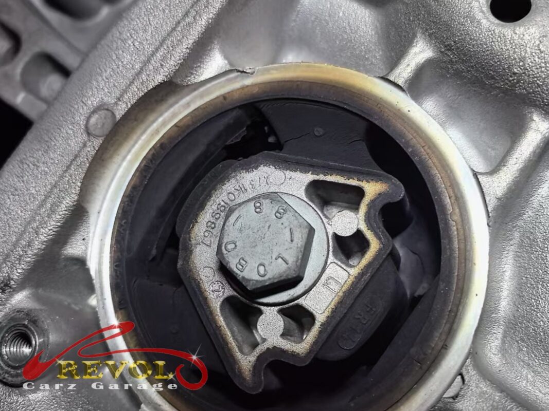 One of the subframe bushings in place, the mounting bolt through the centre.
