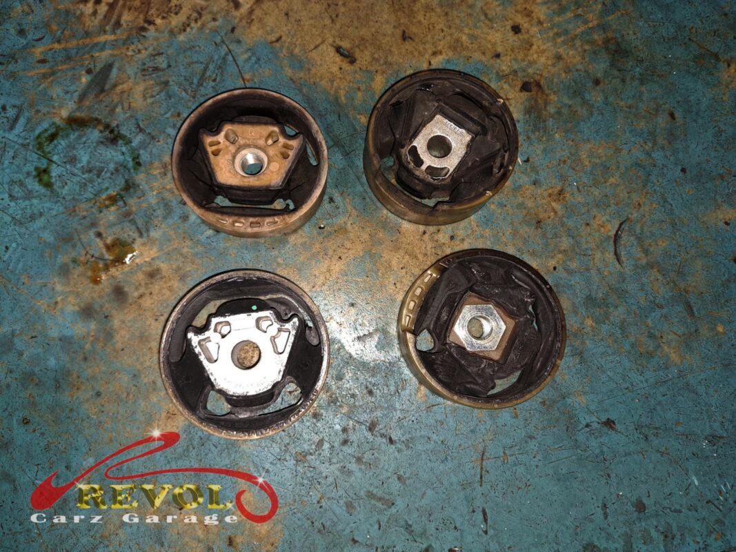 The new VAG-spec subframe bushings (left) beside the worn originals (right).