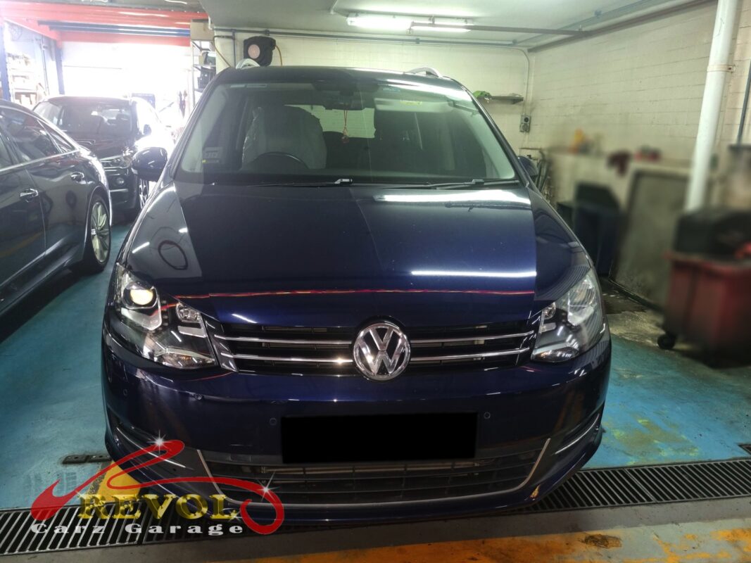Volkswagen Sharan on the workshop lift for thermostat housing replacement.