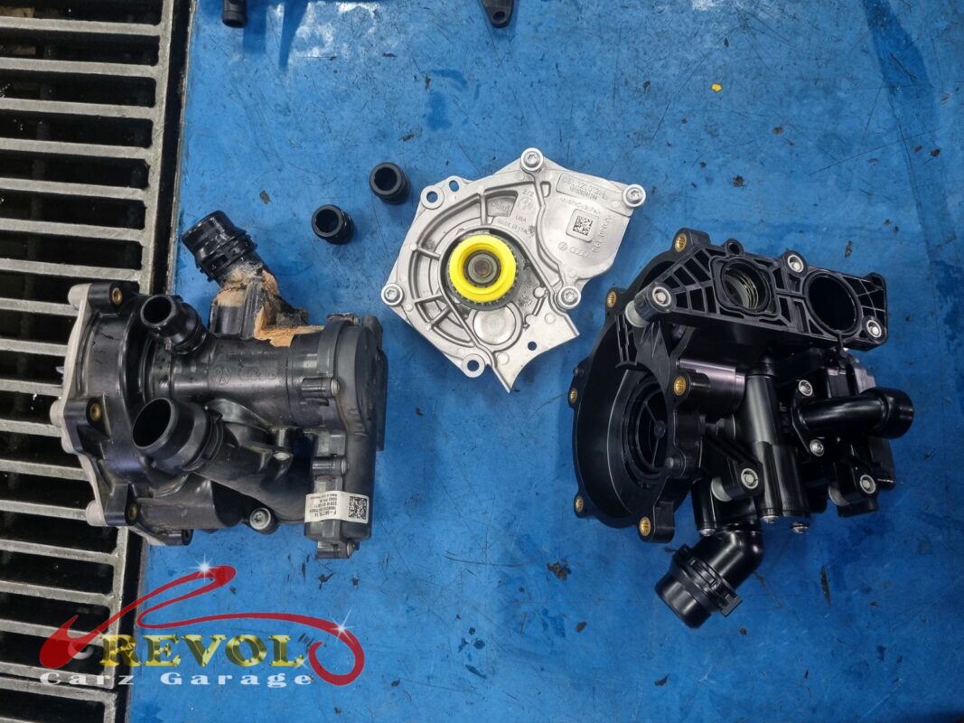 The old fouled module out (left), with the new VAG-spec water pump (centre) and thermostat housing (right) going in.