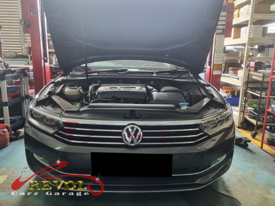 Volkswagen Passat on the workshop lift for oil sump replacement.