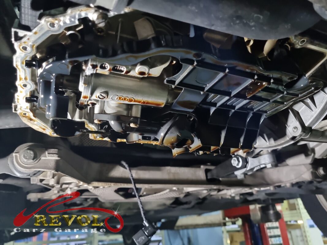 The sump pan off, looking up at the block, the oil pickup and baffle exposed.