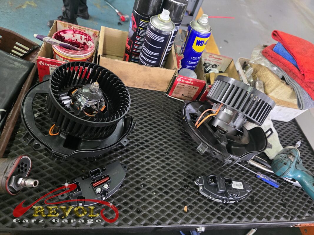 The old cabin blower motor (left) beside the new VAG-spec replacement (right), the speed control module below.