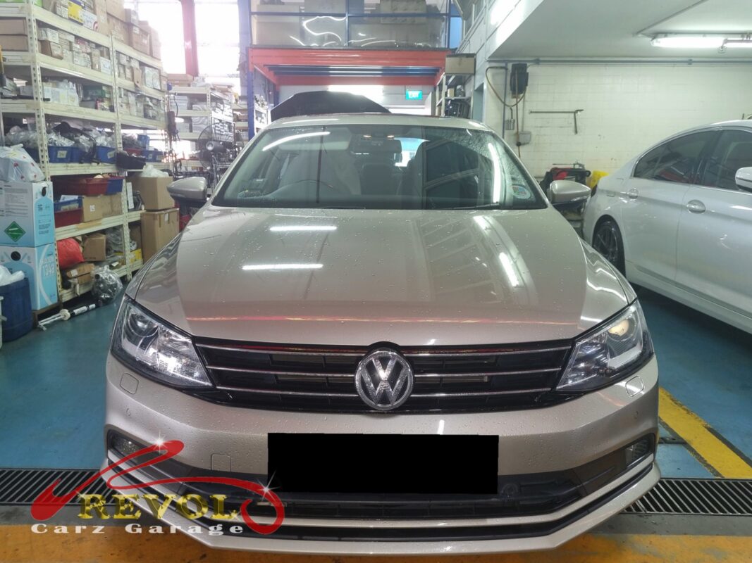 Volkswagen Jetta on the workshop lift for front shock absorber set replacement.