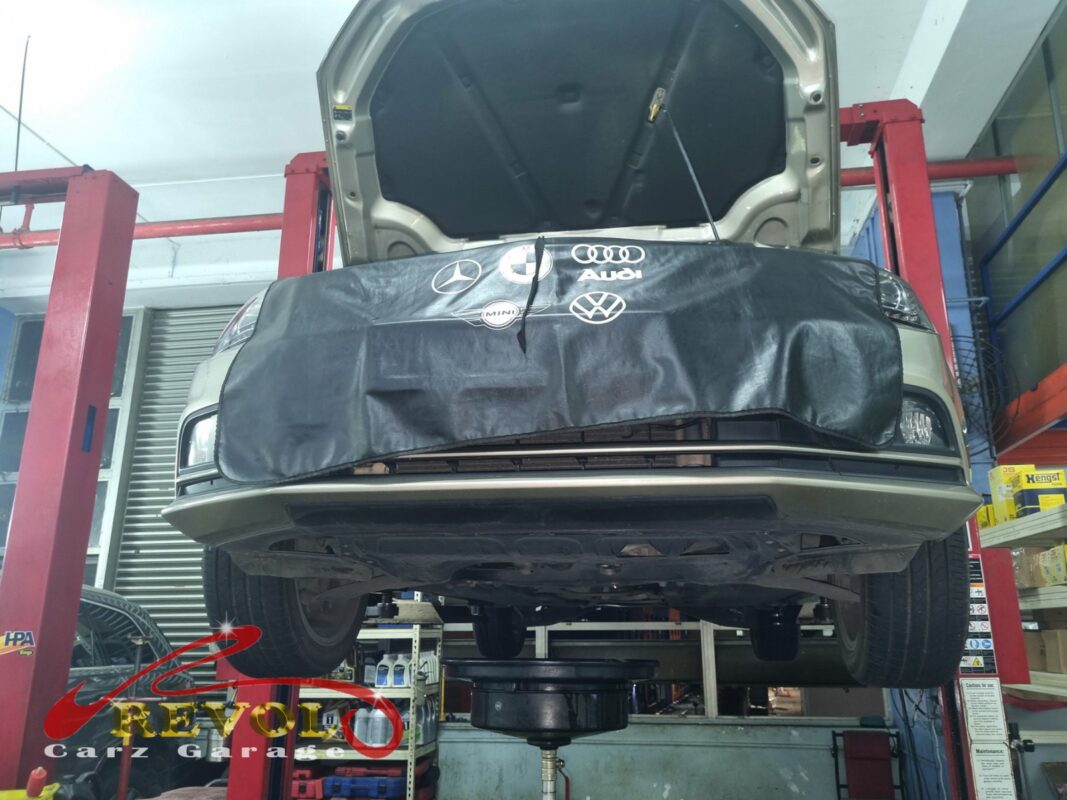 The Jetta up on the two-post lift, bonnet open, in for the bounce and the nose dive.