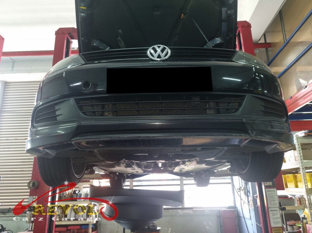 The Jetta up on the two-post lift, bonnet open, in for the knock over humps.
