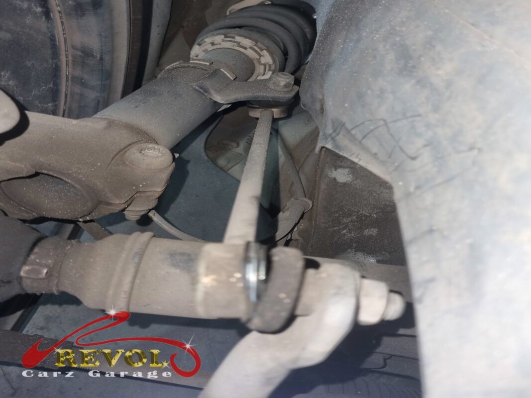 One of the absorber linkages in place, the worn ball ends down at the strut.