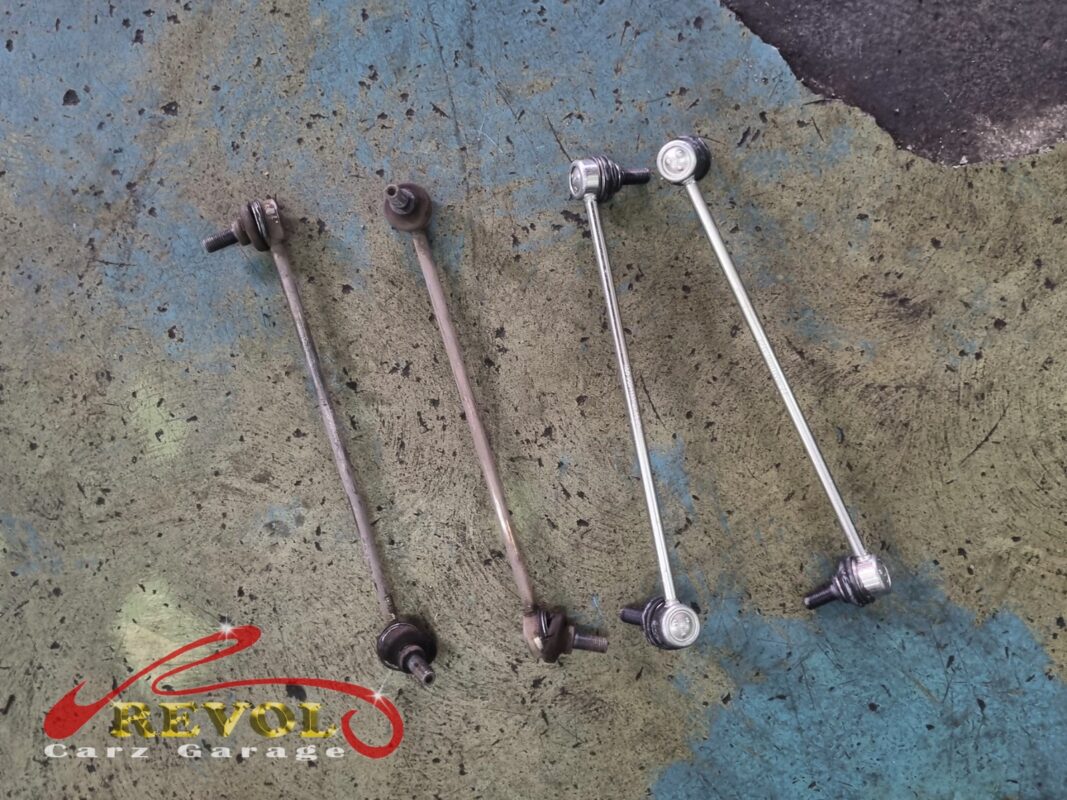 The two old absorber linkages (left, rusted) beside the new VAG-spec pair (right).