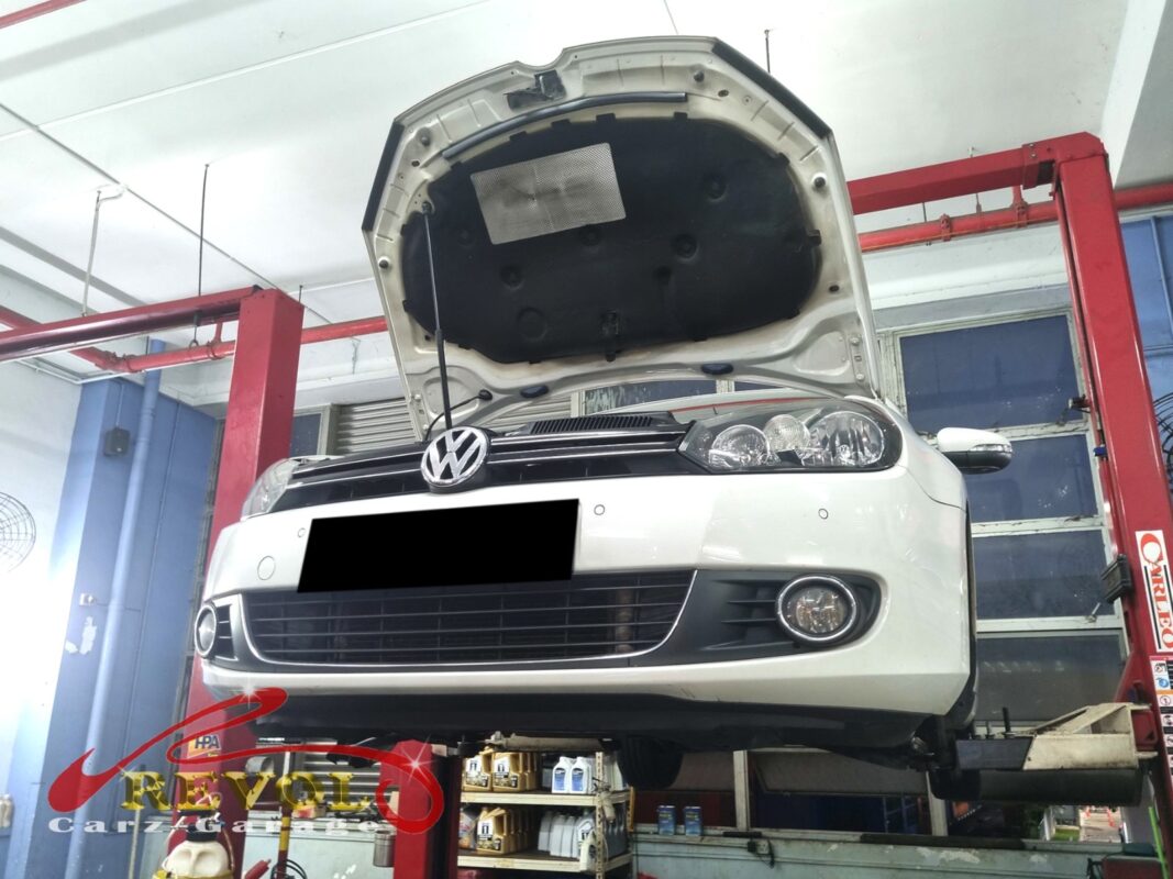 The Golf up on the two-post lift, bonnet open, in for the hum from the front.